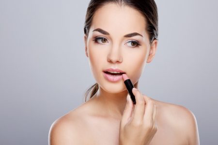 Everything Every Girl Needs in Her Makeup Kit Model Applying Lipstick Beauty