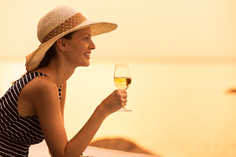 Smiling Woman Holding White Wine Glass Vacation Style