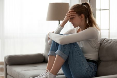 How to Deal with Stress & Anxiety Stressed Woman on Couch