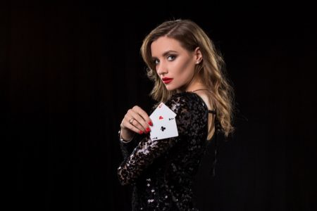 New Casinos and Dress Code Woman Holding Cards Black Sequin Dress