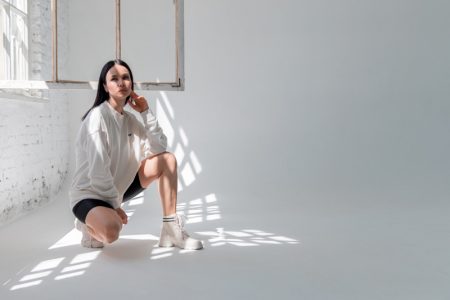 A Look For The Win: Sports' Influence On Fashion Woman Sporty Look Sweater Shots Boots