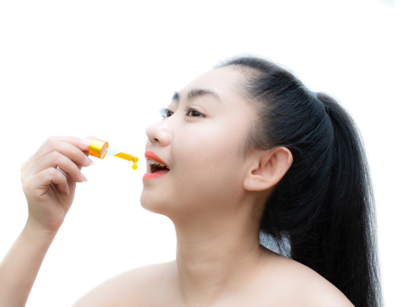 Asian Woman CBD Oil Dropper