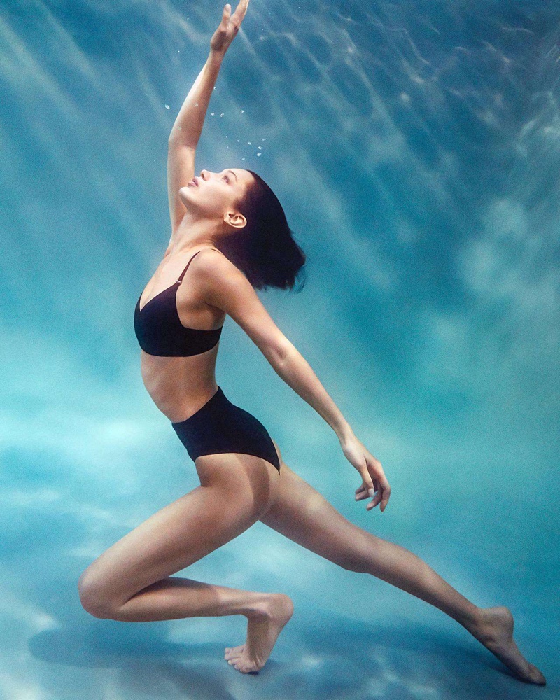 Surrounded by water, Bella Hadid appears in Calvin Klein swimwear summer 2020 campaign.