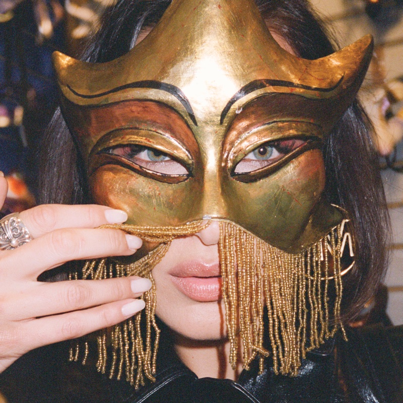 Wearing a mask, Bella Hadid poses in MICHAEL Michael Kors Travel Diaries.