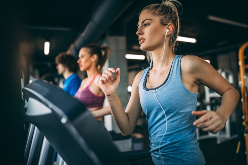 Blonde Woman Running Treadmill Earphones