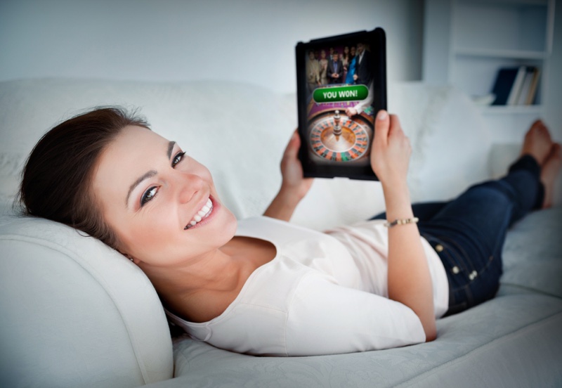 Smiling Woman Couch Tablet Online