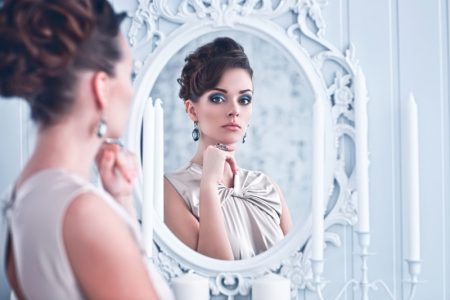 Decorate with Stylish Reflections from Bassett Mirror Company Stylish Woman Looking Mirror Brunette Elegant