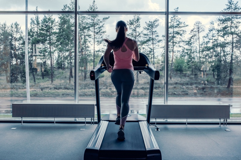 Woman Running Treadmill From Behind Pink Top