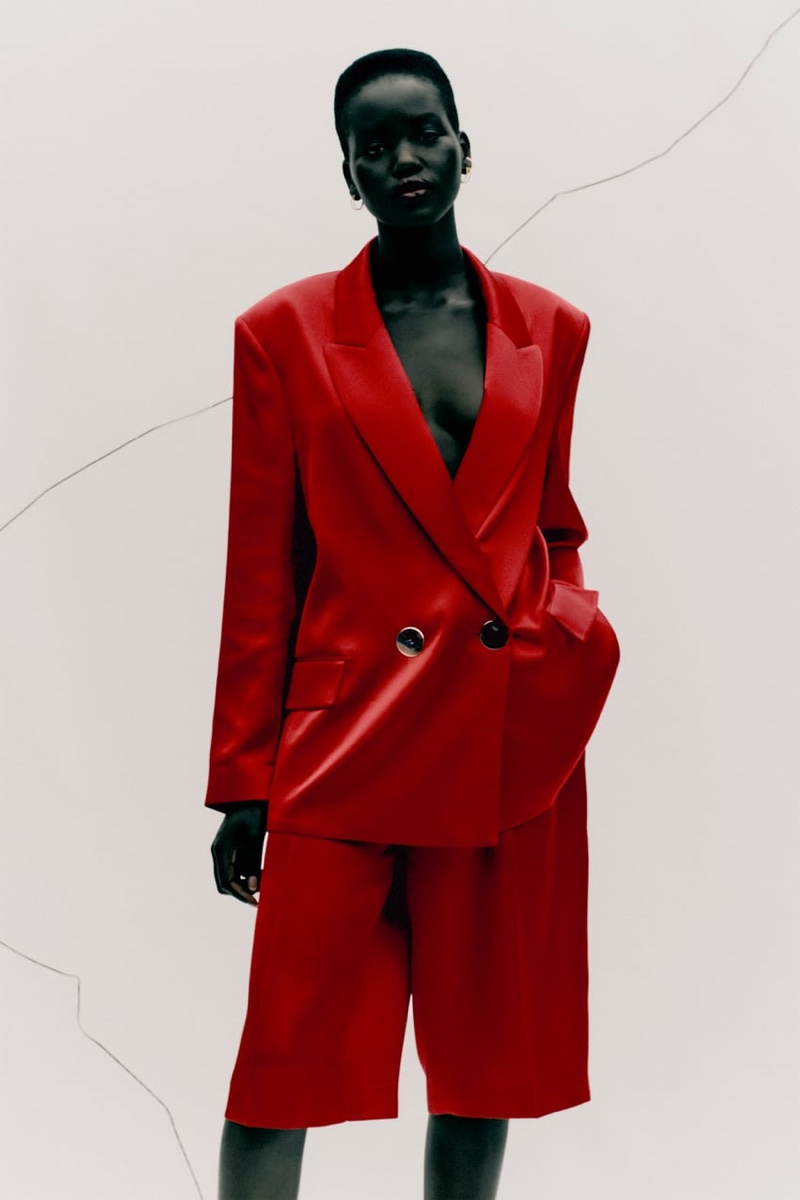 Adut Akech models Zara satin effect blazer and pleated satin effect shorts.