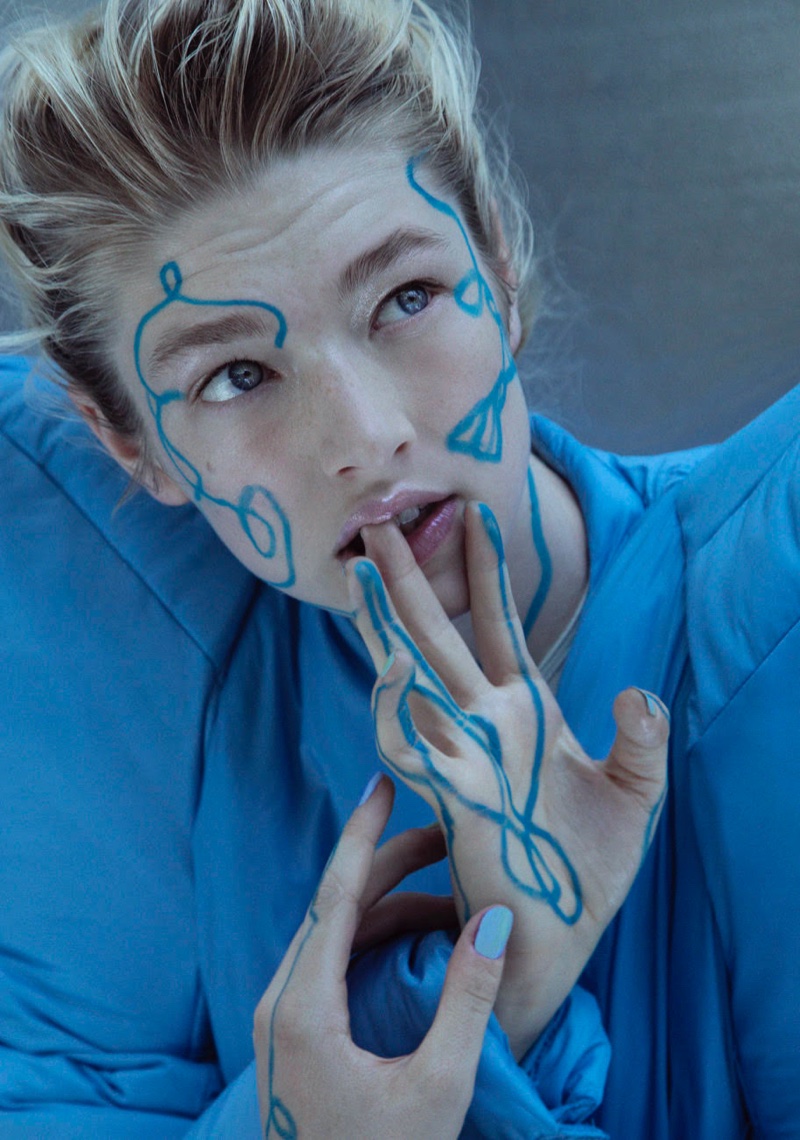 Painted in blue, Hunter Schafer wears a dramatic look.