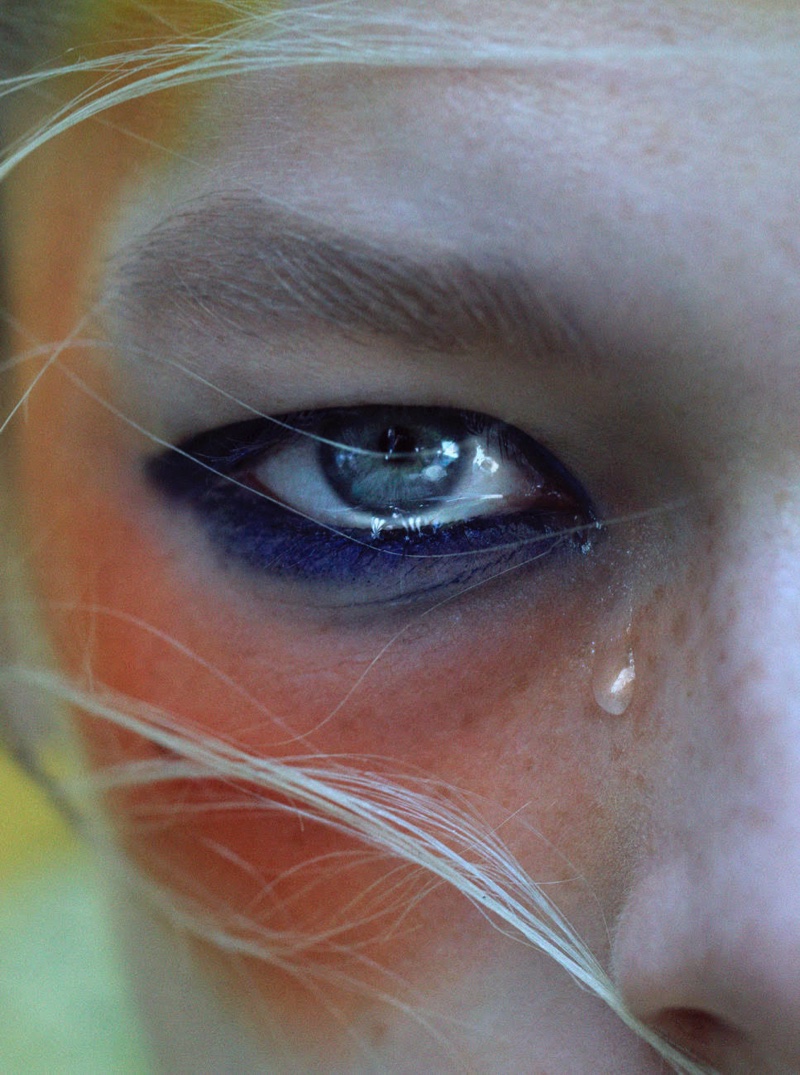 Hunter Schafer wears multi-colored makeup.