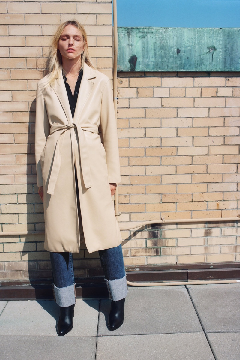 Model Sasha Pivovarova layers up in Zara faux leather trench coat.