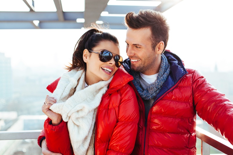 Smiling Couple Red Jackets Outdoors