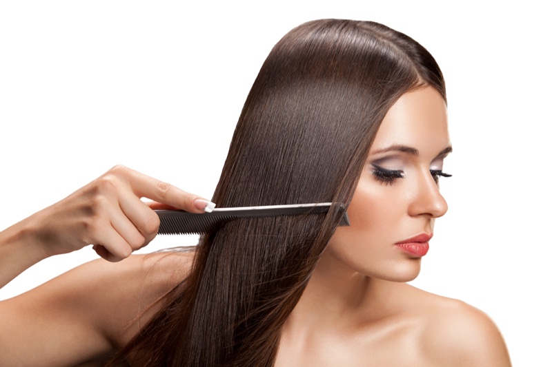 Woman Combing Long Dark Hair Beauty