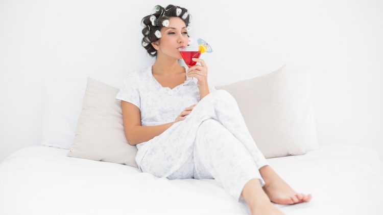Woman Enjoying Cocktail in Bed