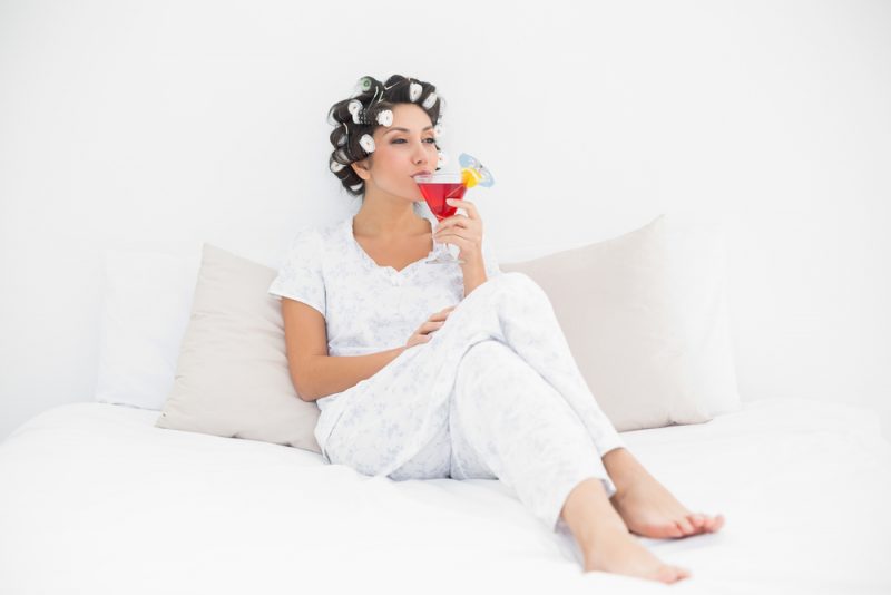 Woman Enjoying Cocktail in Bed