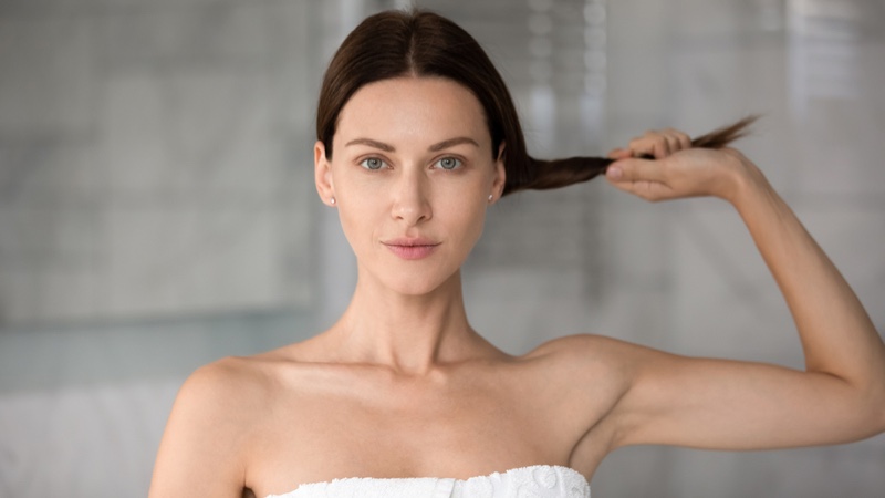 Woman Holding Thin Hair Bathroom