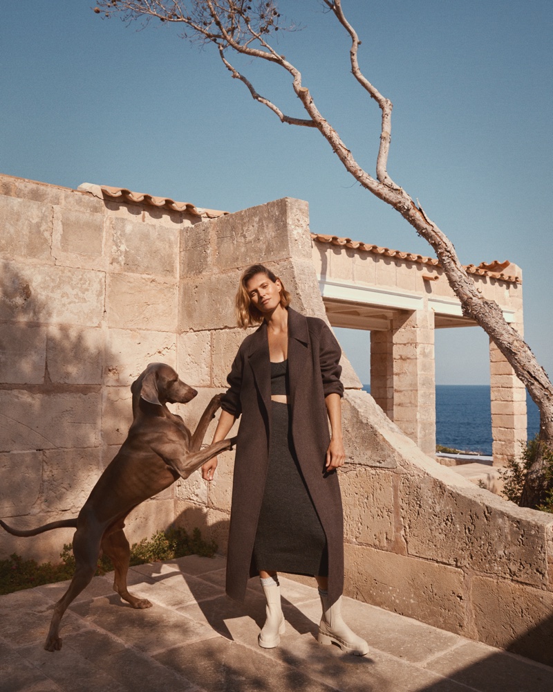 Posing with a dog, Malgosia Bela models Mango fall 2020 collection.