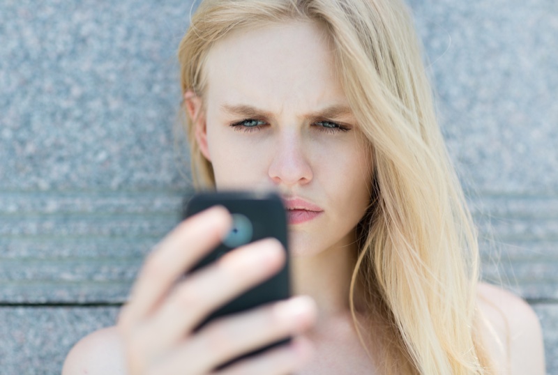 Woman Looking Phone Concerned Face