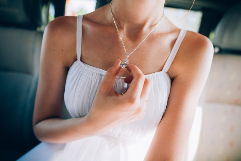 Woman in White Dress Wearing Silver Necklace