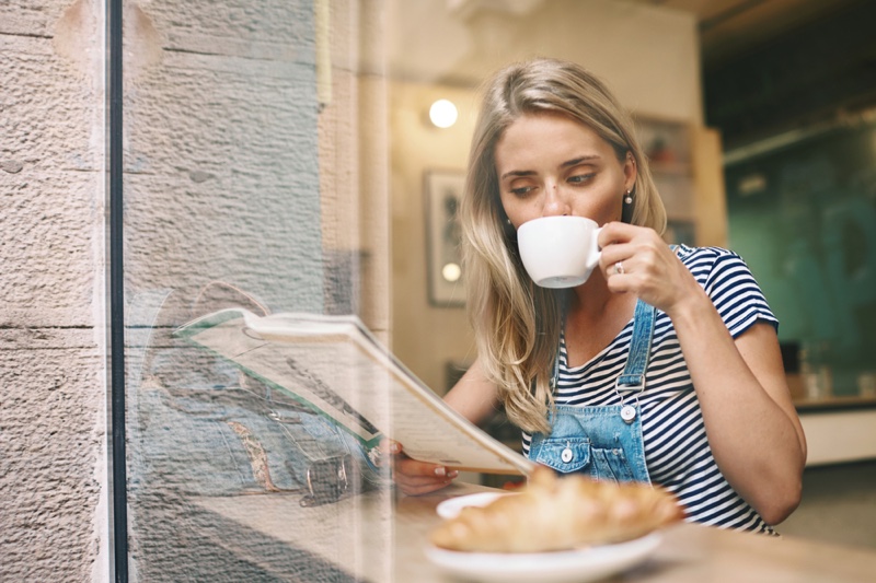 Blonde Woman Reading Magazine Drinking Coffee Cafe