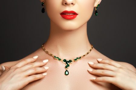 5 Colored Gemstone Jewelry Pieces That Every Woman Should Have Closeup Model Emerald Earrings Necklace Red Lipstick