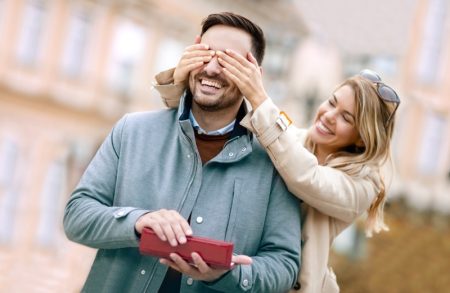 2020 Gifts for Men – How to Buy the Best Present for Your Boyfriend Girlfriend Covering Man's Eyes Gift Smiling Couple Happy