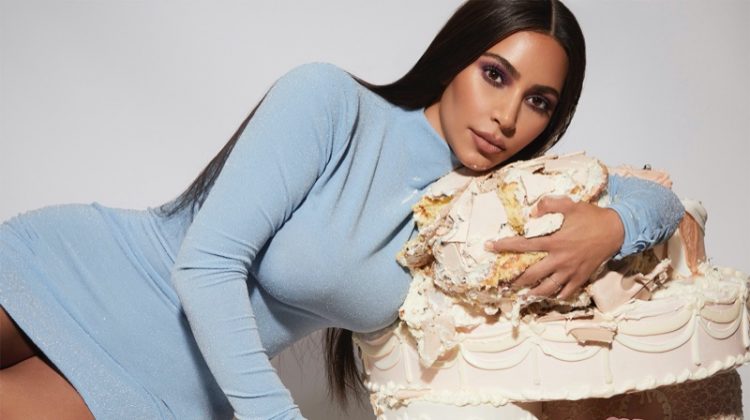 Kim Kardashian poses with cake for KKW Beauty Opalescent campaign.