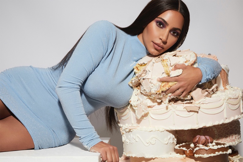 Kim Kardashian poses with cake for KKW Beauty Opalescent campaign.