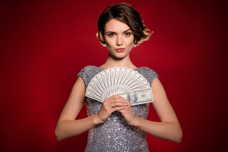 Model Holding Fanned Money Hundred Bills Silver Sequin Dress