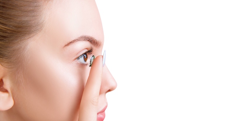 Woman Applying Green Colored Contact Lenses