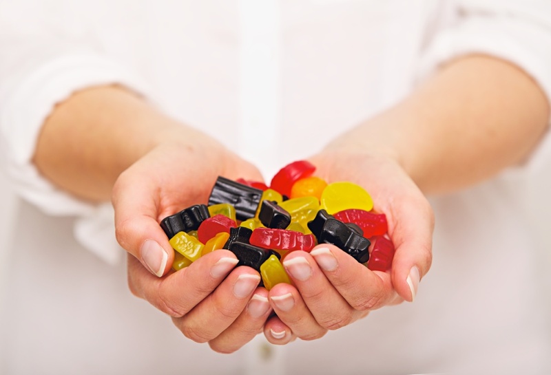 Woman Holding Multicolored Gummies Hands