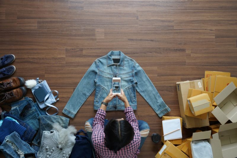 Woman Taking Picture of Denim Jacket