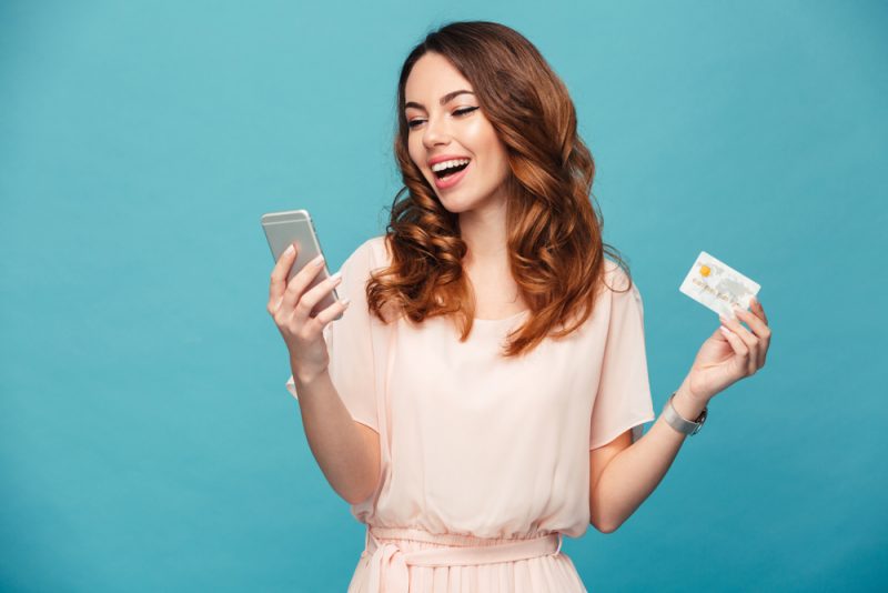Woman Using Phone App with Credit Card