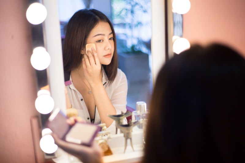 Asian Girl Applying Makeup Lighted Vanity Mirror