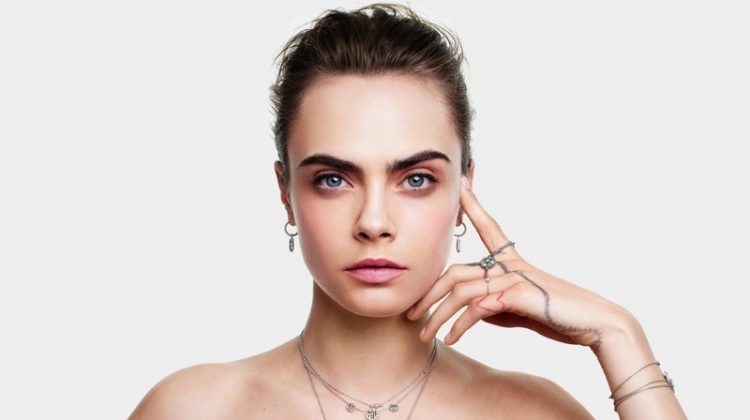 Wearing red, Cara Delevingne is the face of Dior Joaillerie's Christmas 2020 campaign.