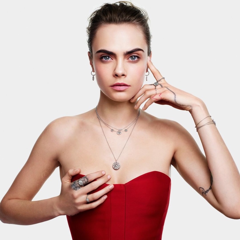 Wearing red, Cara Delevingne is the face of Dior Joaillerie's Christmas 2020 campaign.