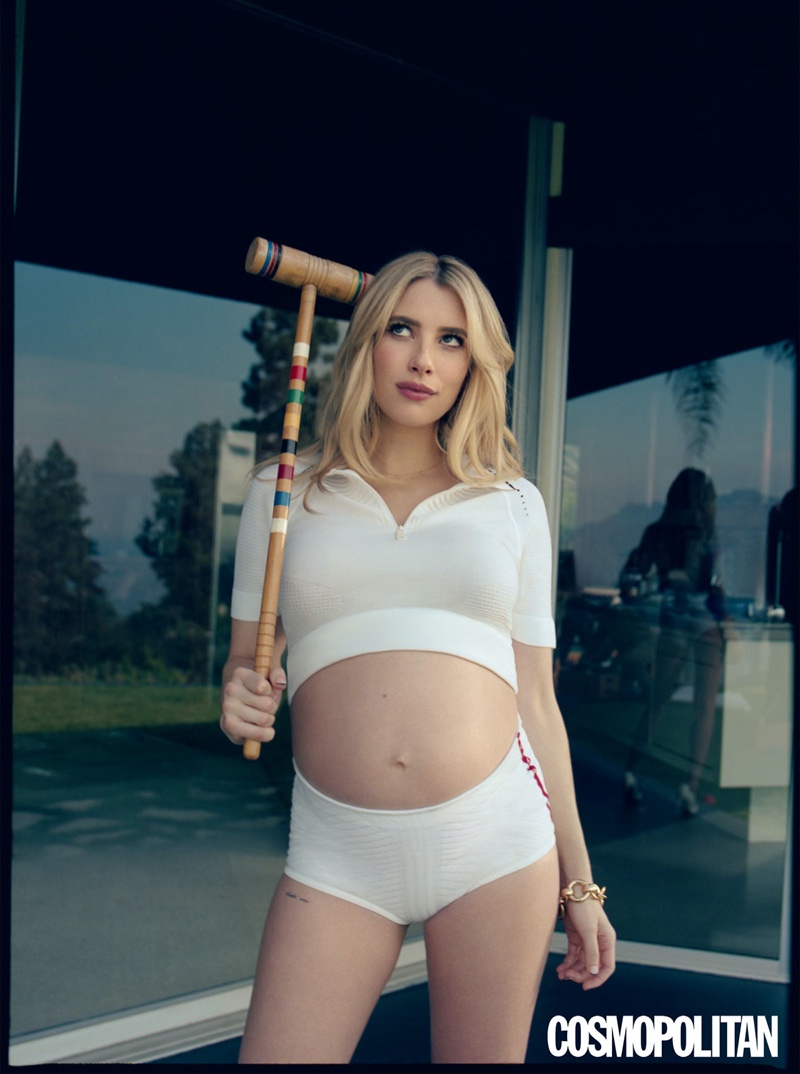 Posing with a croquet mallet, Emma Roberts wears Prada shirt and shorts with Laura Lombardi bracelet.