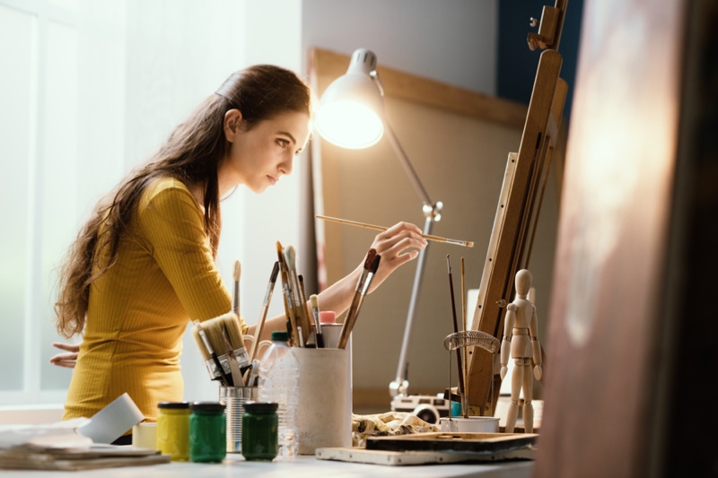 Female Artist Painting Yellow Top