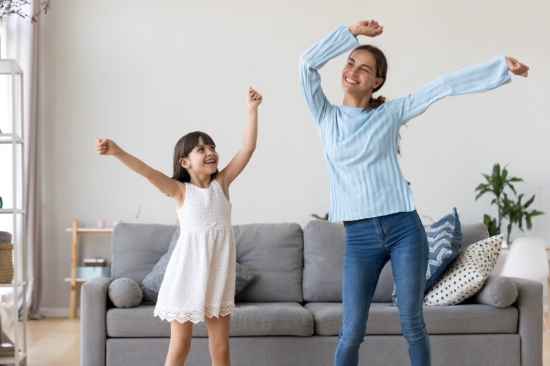 Mother Daughter Dancing Living Room Couch