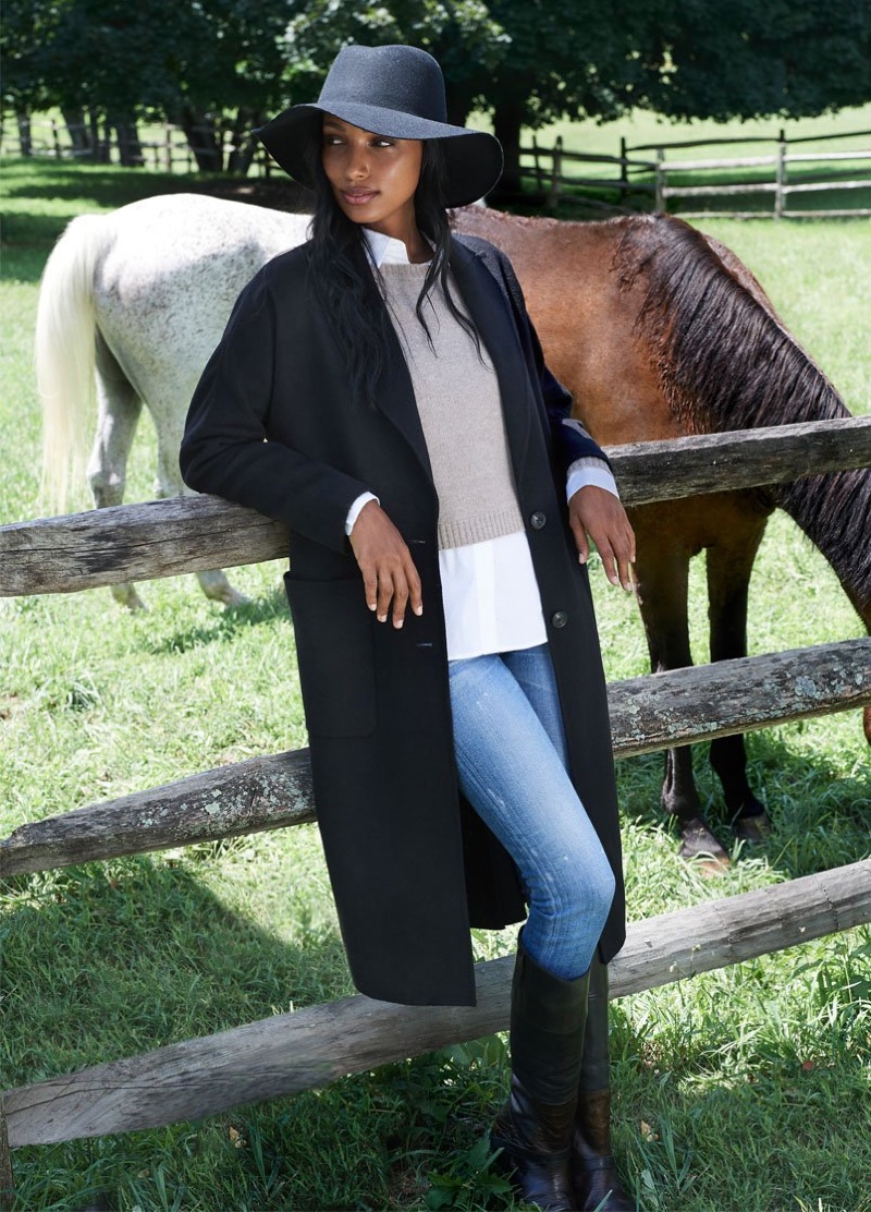 Jasmine Tookes poses next to horses in Naked Cashmere fall-winter 2020 campaign.