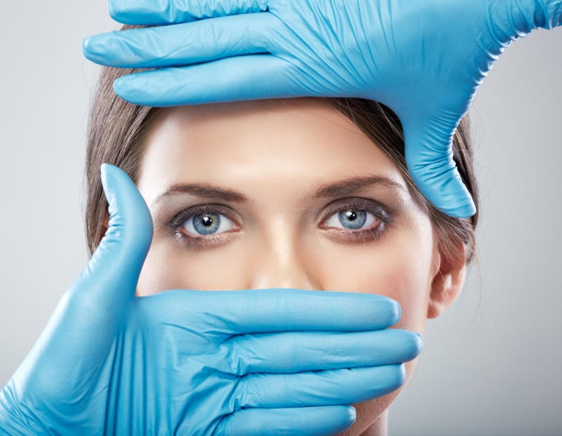 Plastic Surgeon's Hands Woman's Face Showing Eyes