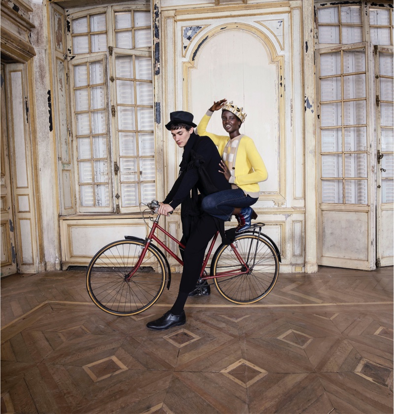 Posing on a bicycle, Anok Yai fronts Tory Burch Holiday 2020 campaign.
