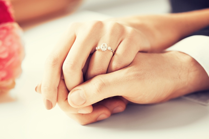 Woman Man Holding Hands Engagement Ring Side Stones