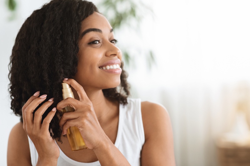 Woman Spraying Curly Hair