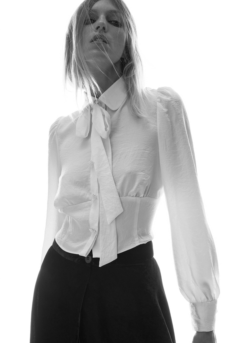 Anja Rubik wears Zara shirt with bow.