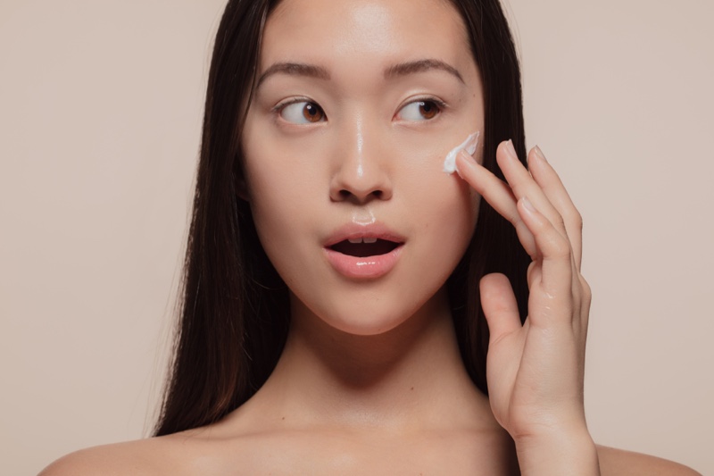 Asian Model Applying Face Cream