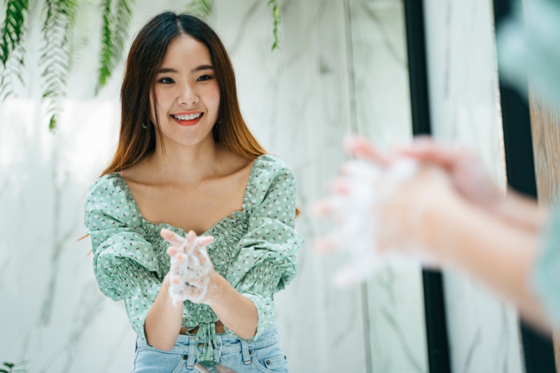 Asian Woman Washing Hands Happy Green Top Mirror