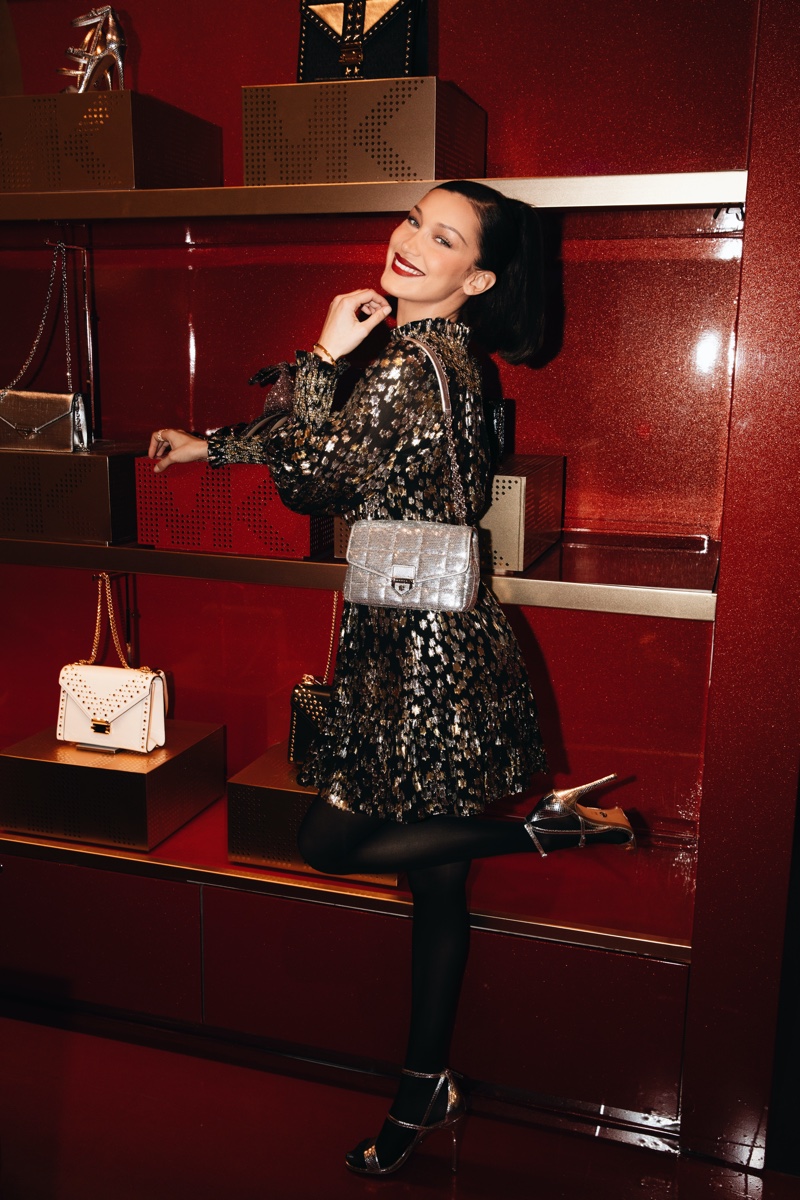 Celebrating holiday style, Bella Hadid poses at Michael Kors MK Edited By... event at Macy's Herald Square.