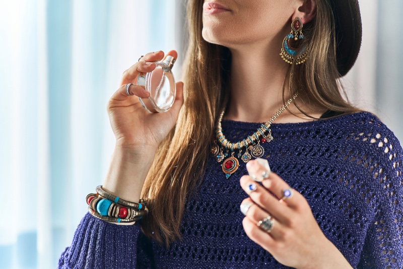 Bohemian Woman Holding Fragrance Bottle Layered Jewelry